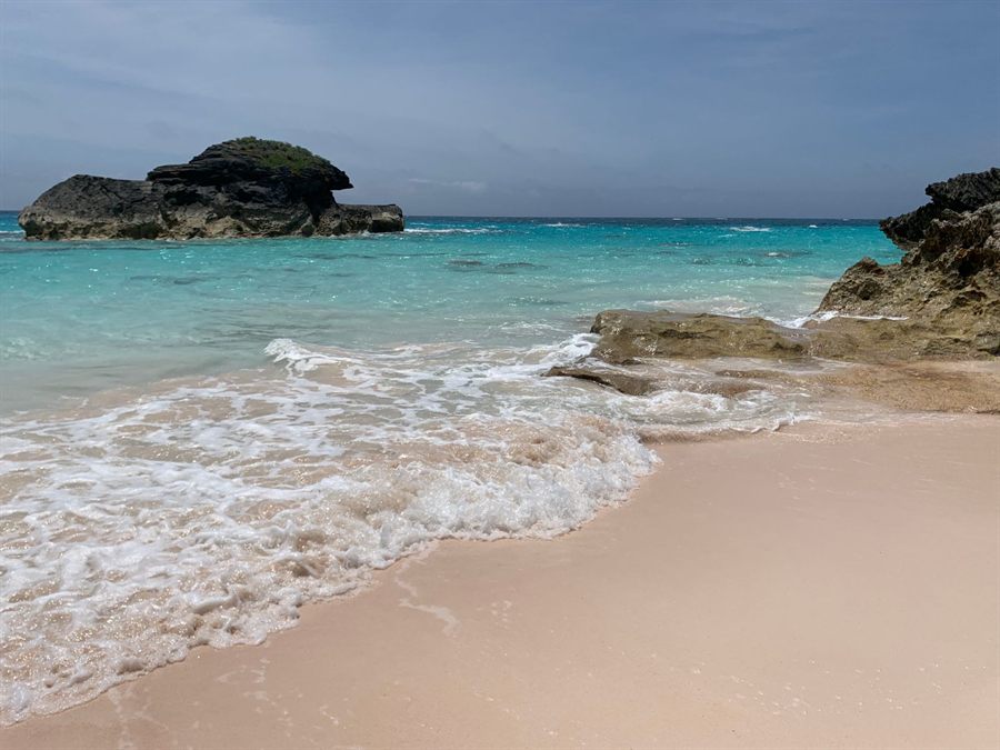 Sandy Bermuda cove with turquoise water and rock formations