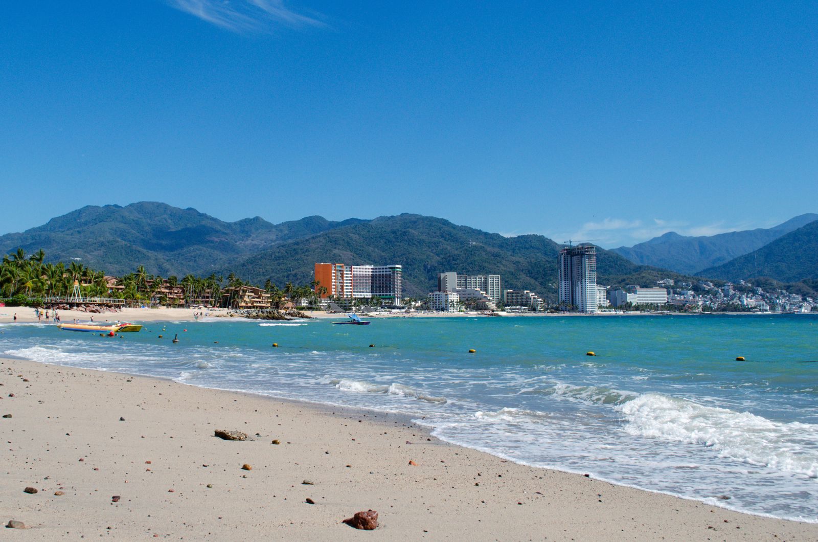 Beach in Puerto Vallarta with the city and hills behind
